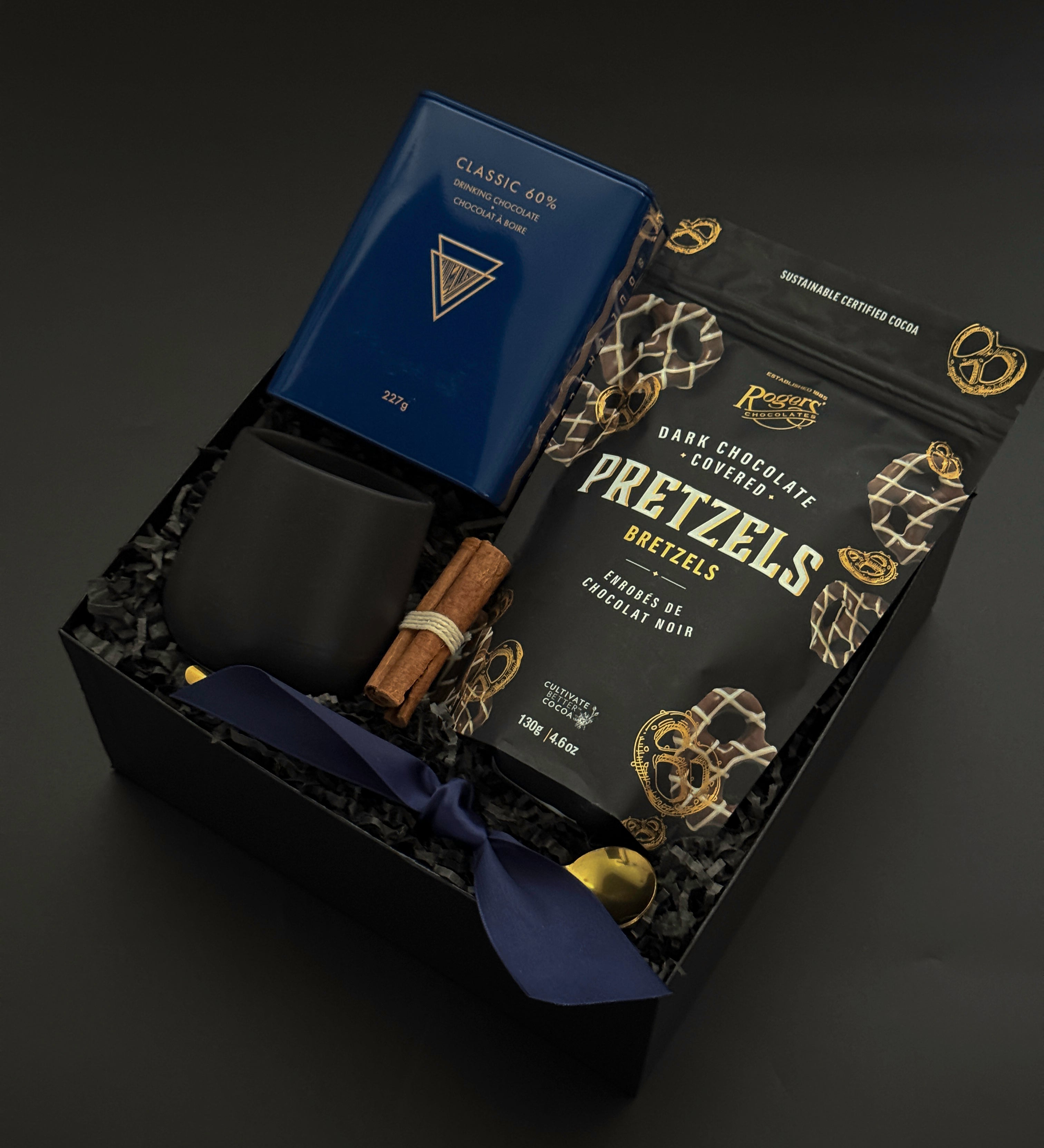 Flat lay of the Midnight Cocoa Gift Box featuring rich drinking chocolate, modern stoneware, and golden details, a luxurious take on a cozy winter ritual.