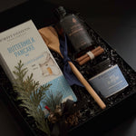 Cozy winter breakfast gift basket with Canadian gourmet products and olive wood utensil.