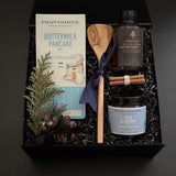 Holiday breakfast gift set with maple syrup and cinnamon bundle in black gift box.