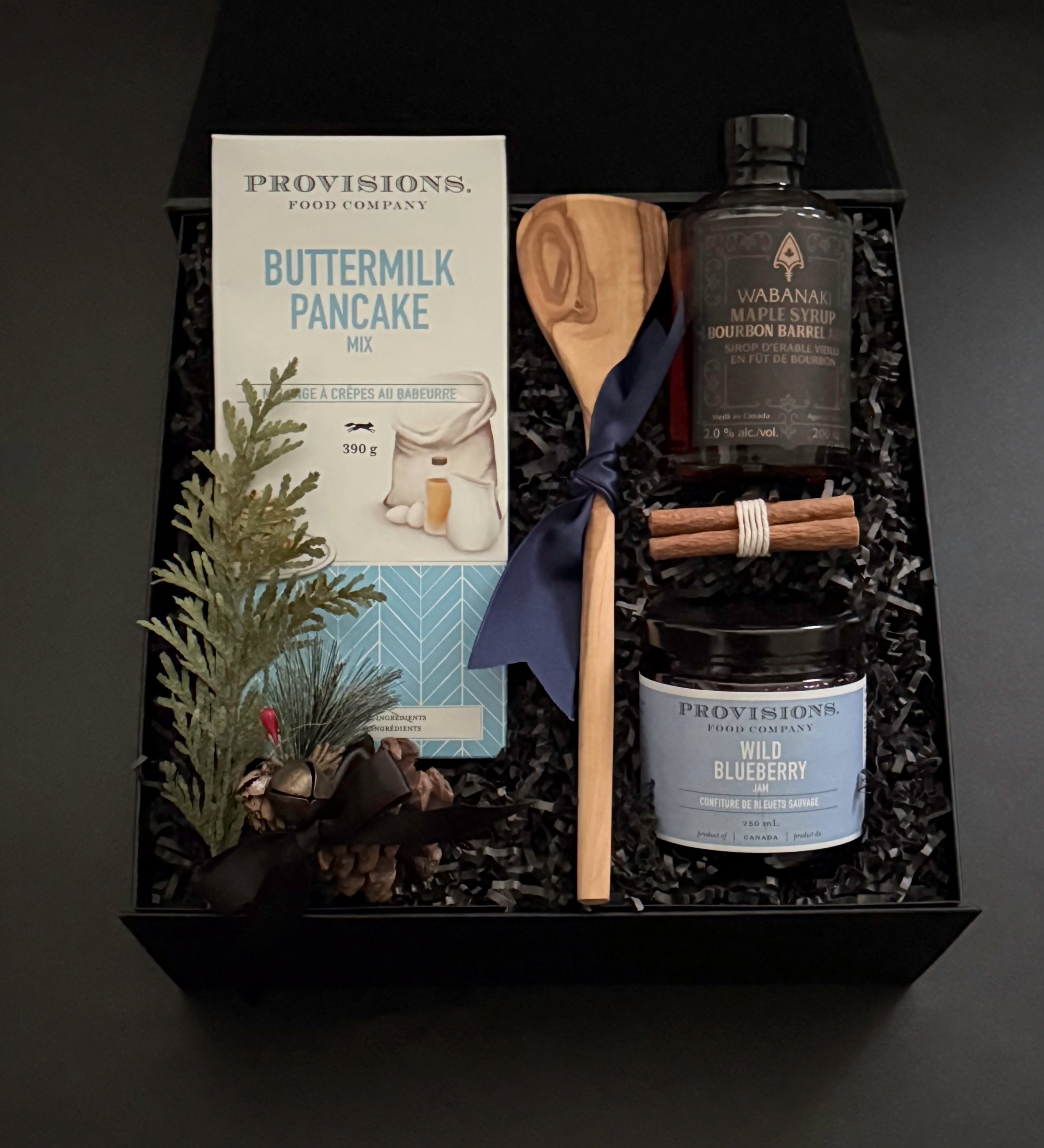 Holiday breakfast gift set with maple syrup and cinnamon bundle in black gift box.