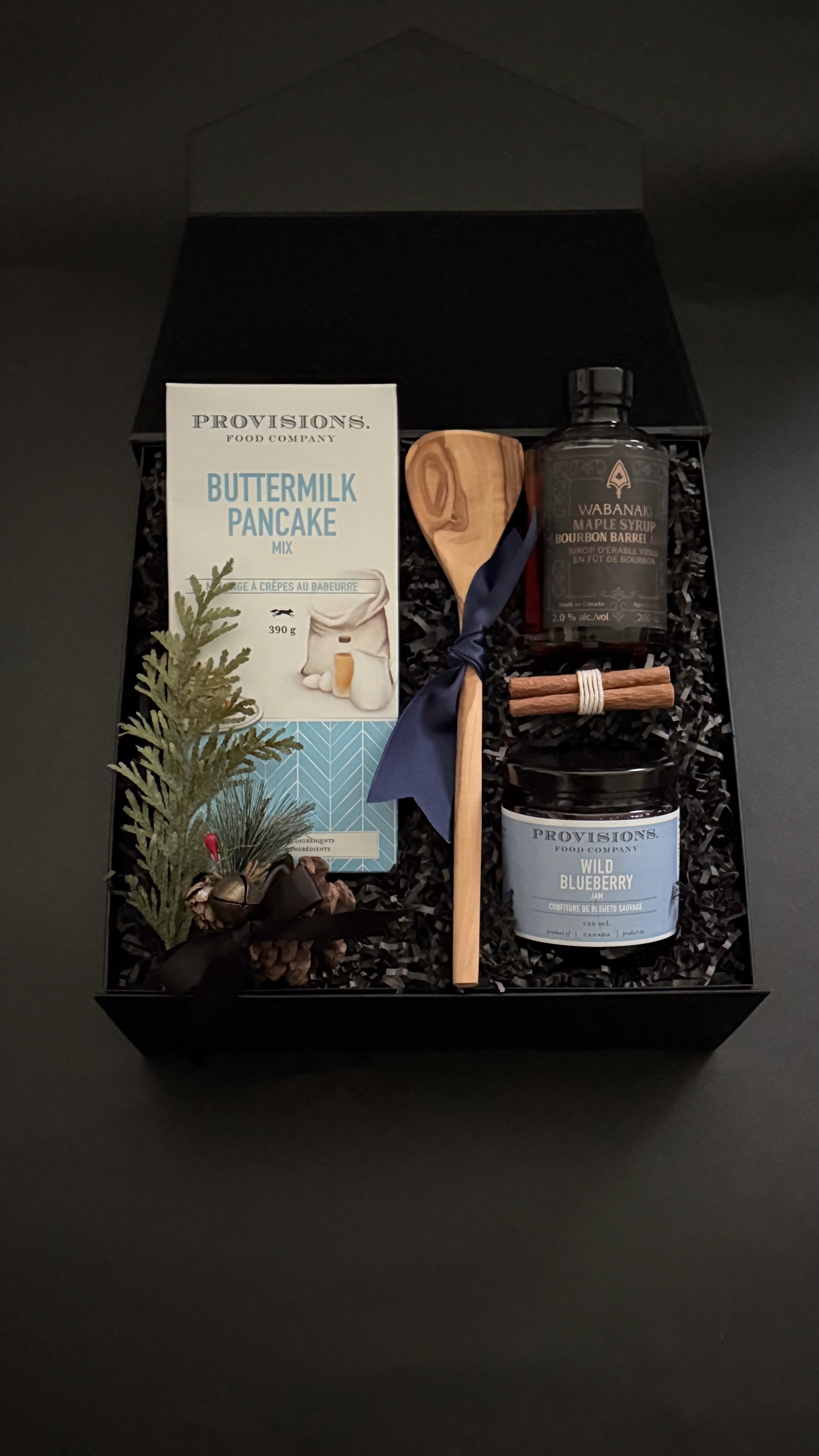 Holiday breakfast gift set with maple syrup and cinnamon bundle in black gift box.