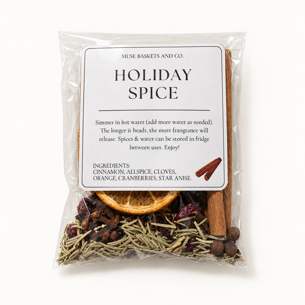 Muse Baskets Holiday Spice simmering sachet with dried orange, cinnamon, cranberries and aromatic spices on an ivory background.