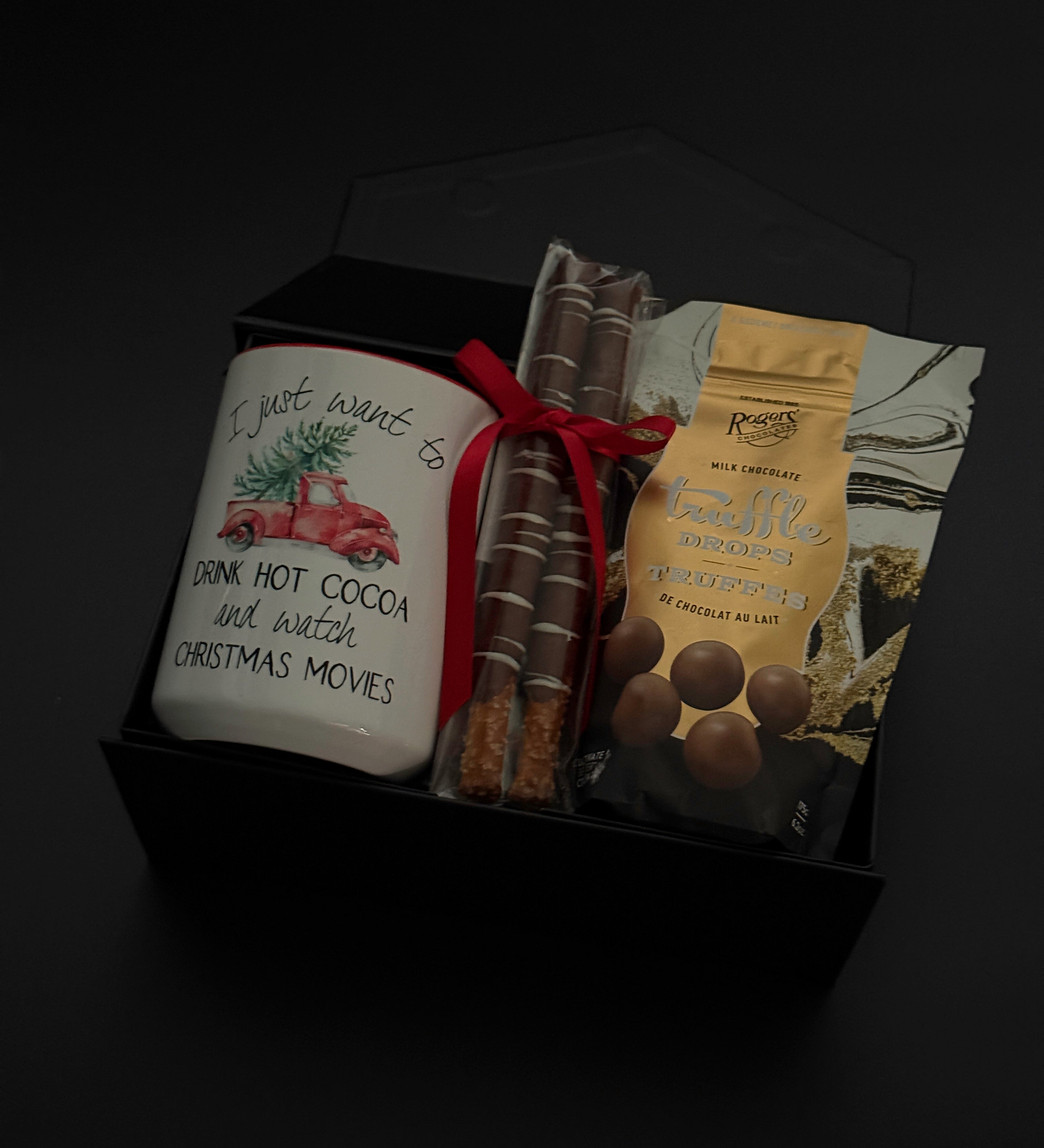 Corporate holiday gift box featuring a hot chocolate mug, chocolate truffles, and pretzels.