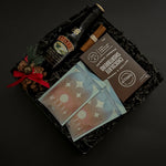 Seasonal gift basket featuring Baileys, hot chocolate, and chocolate shortbread cookies.