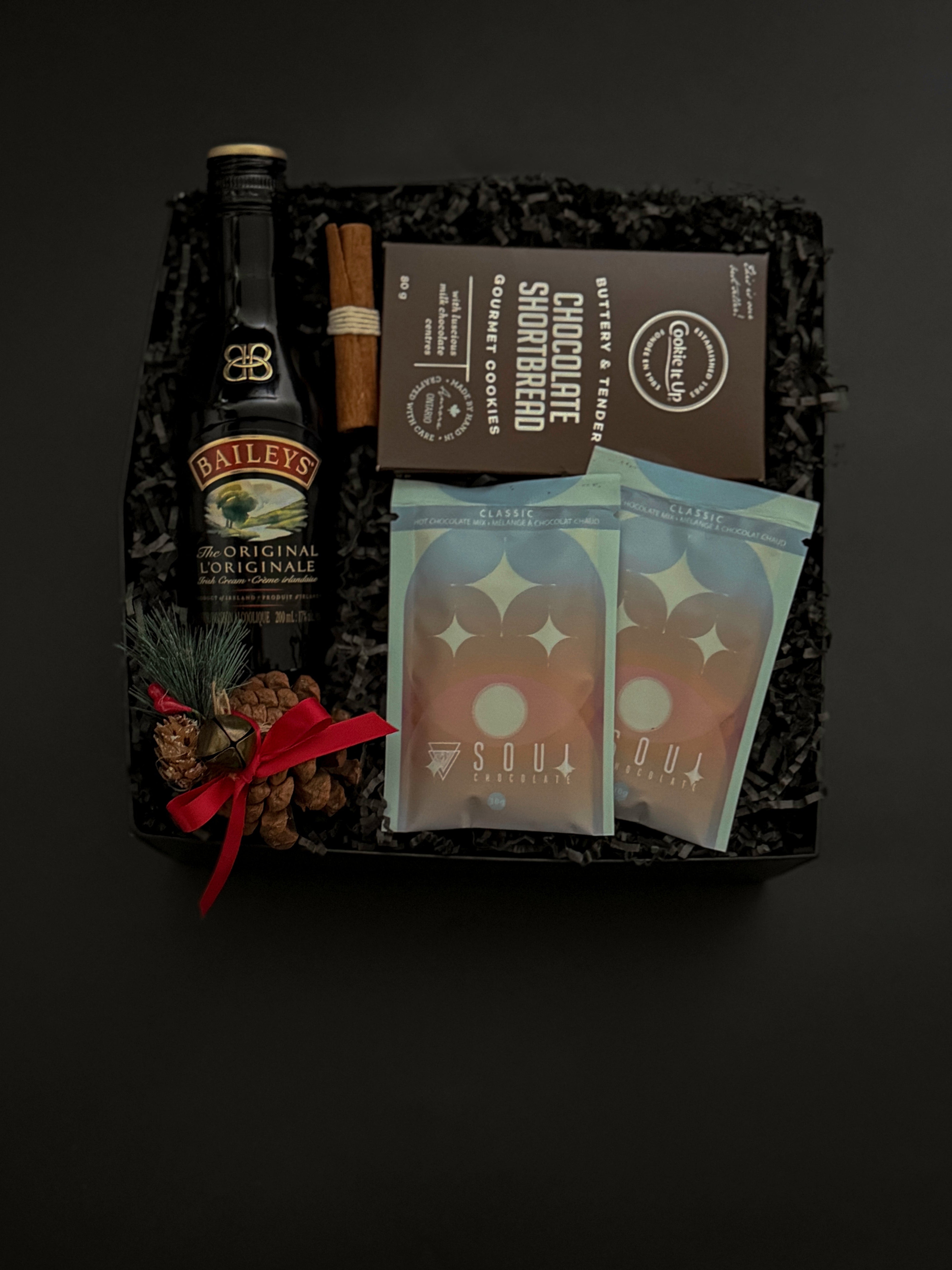 Holiday gift box with Baileys, artisan hot chocolate, and cookies.