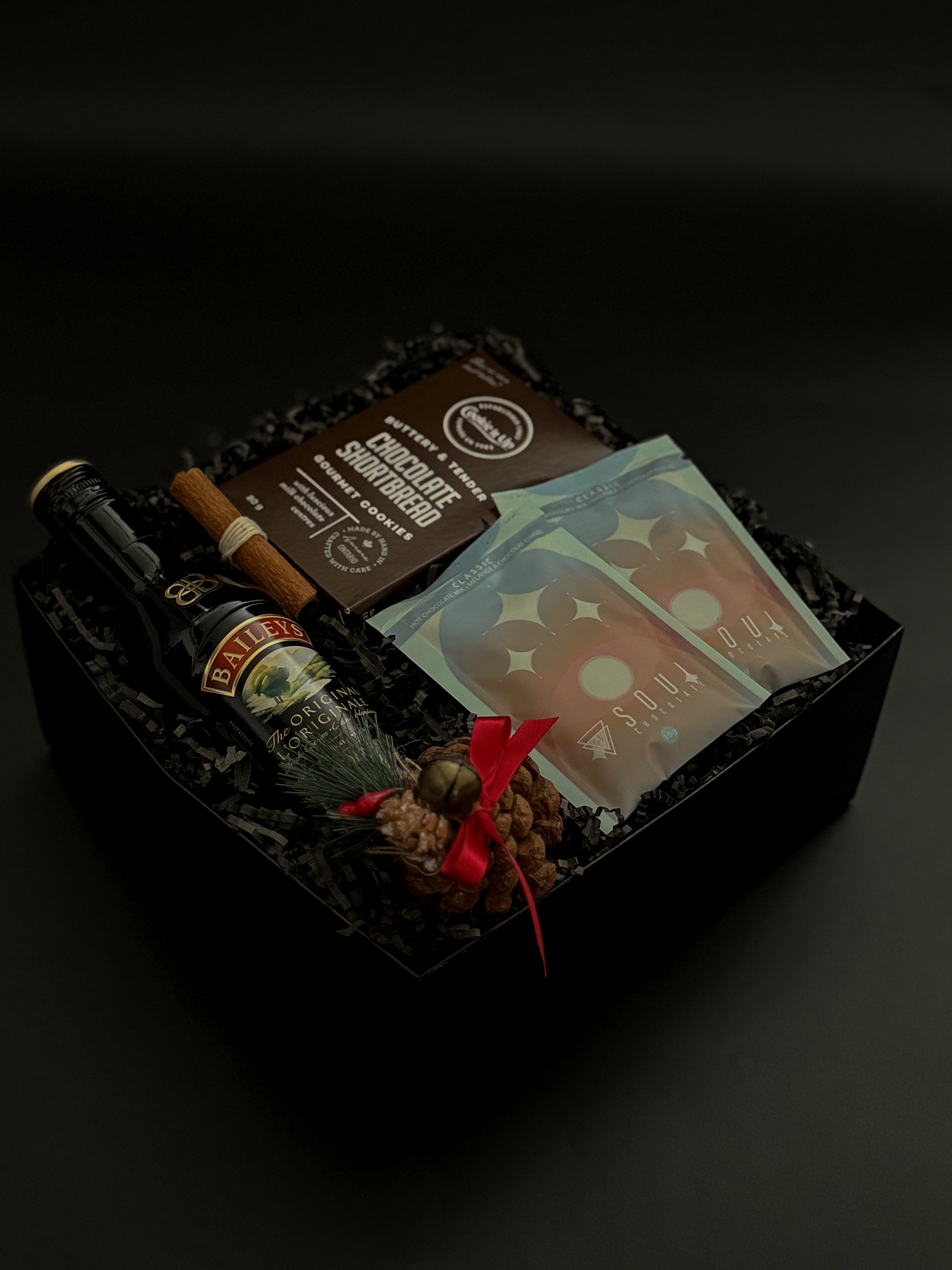 Corporate holiday gift with Baileys, shortbread cookies, and festive accents.