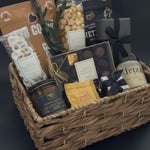 Modern housewarming gift basket with premium Canadian chocolates, caramel popcorn, honey, and candle curated for an elevated city welcome