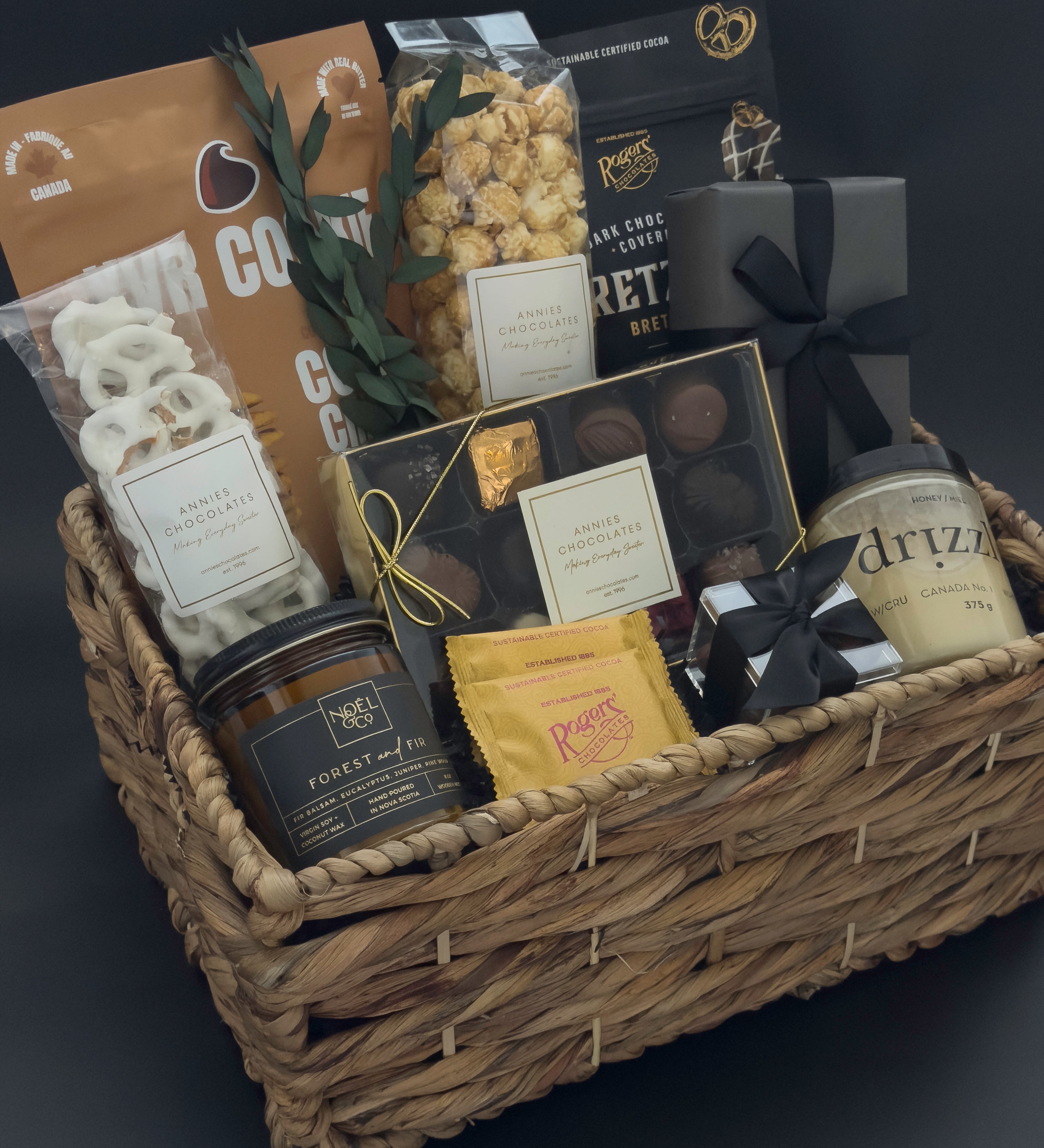 Modern housewarming gift basket with premium Canadian chocolates, caramel popcorn, honey, and candle curated for an elevated city welcome