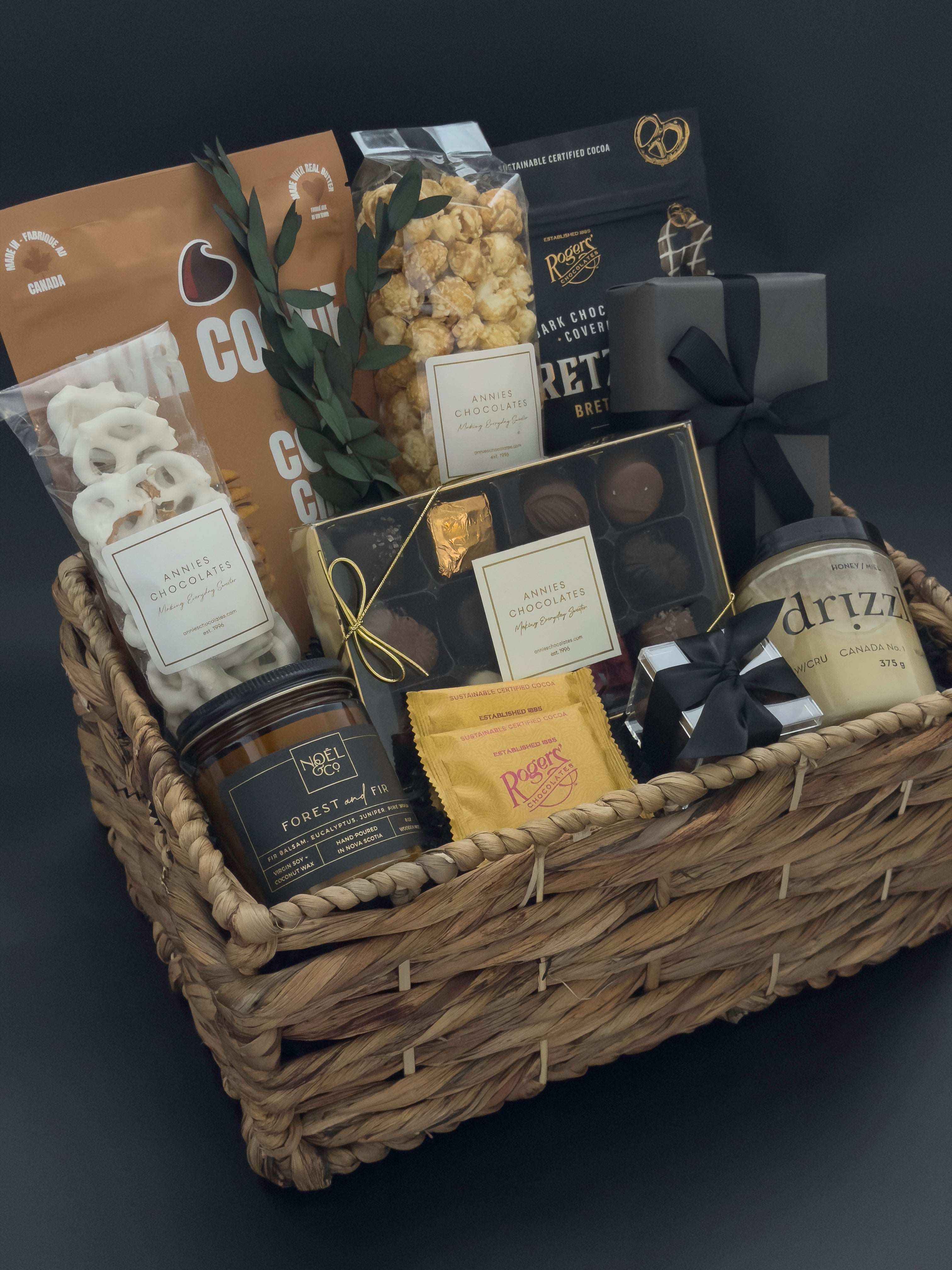 Modern housewarming gift basket with premium Canadian chocolates, caramel popcorn, honey, and candle curated for an elevated city welcome