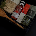 Olive wood spoon and Castelvetrano olives displayed beside the gift box — highlighting the elegant details and craftsmanship.