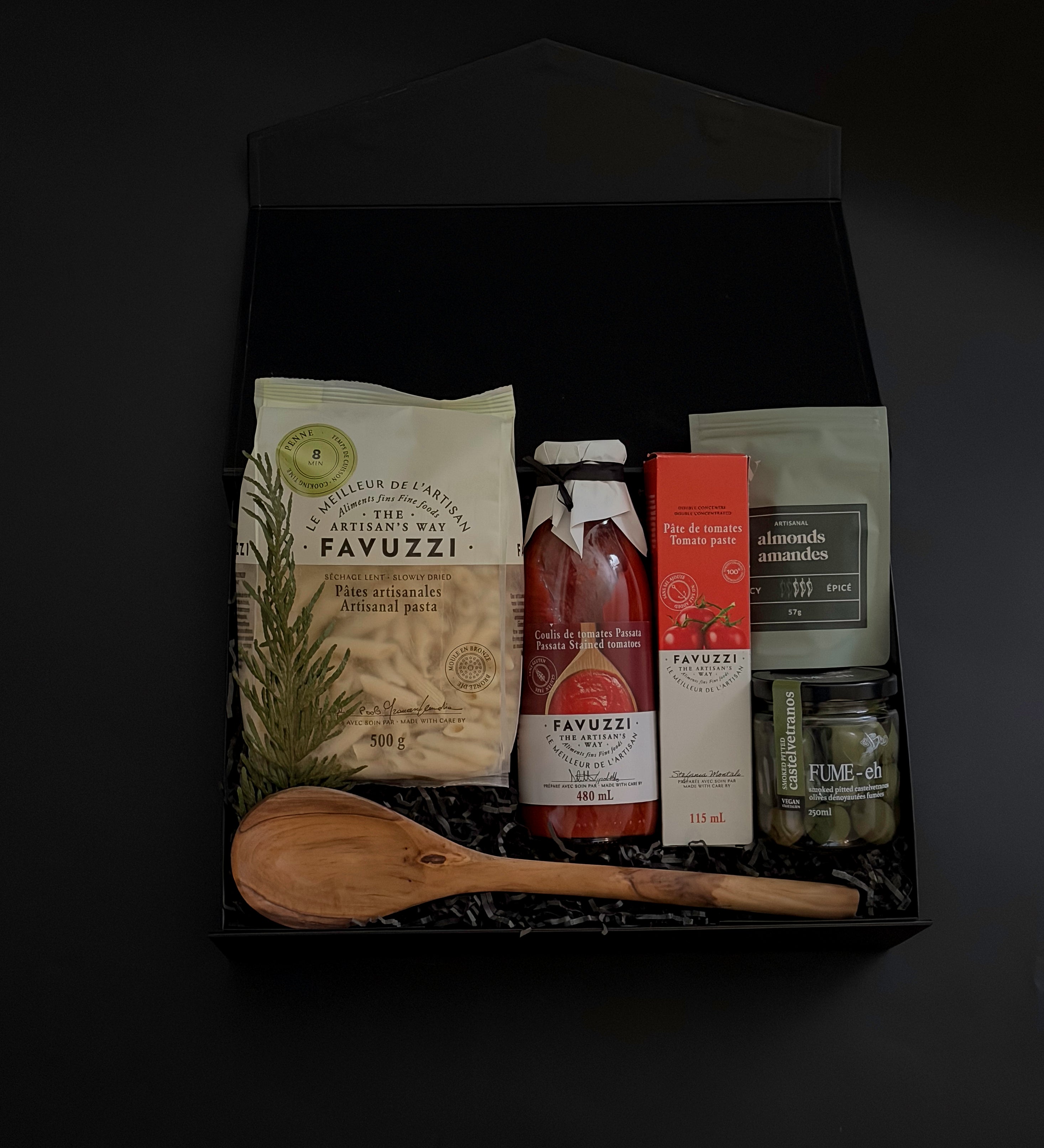 Flat lay of La Tavola Italiana Gift Box — black box filled with artisanal pasta, passata, and gourmet accompaniments, styled elegantly on a marble surface.