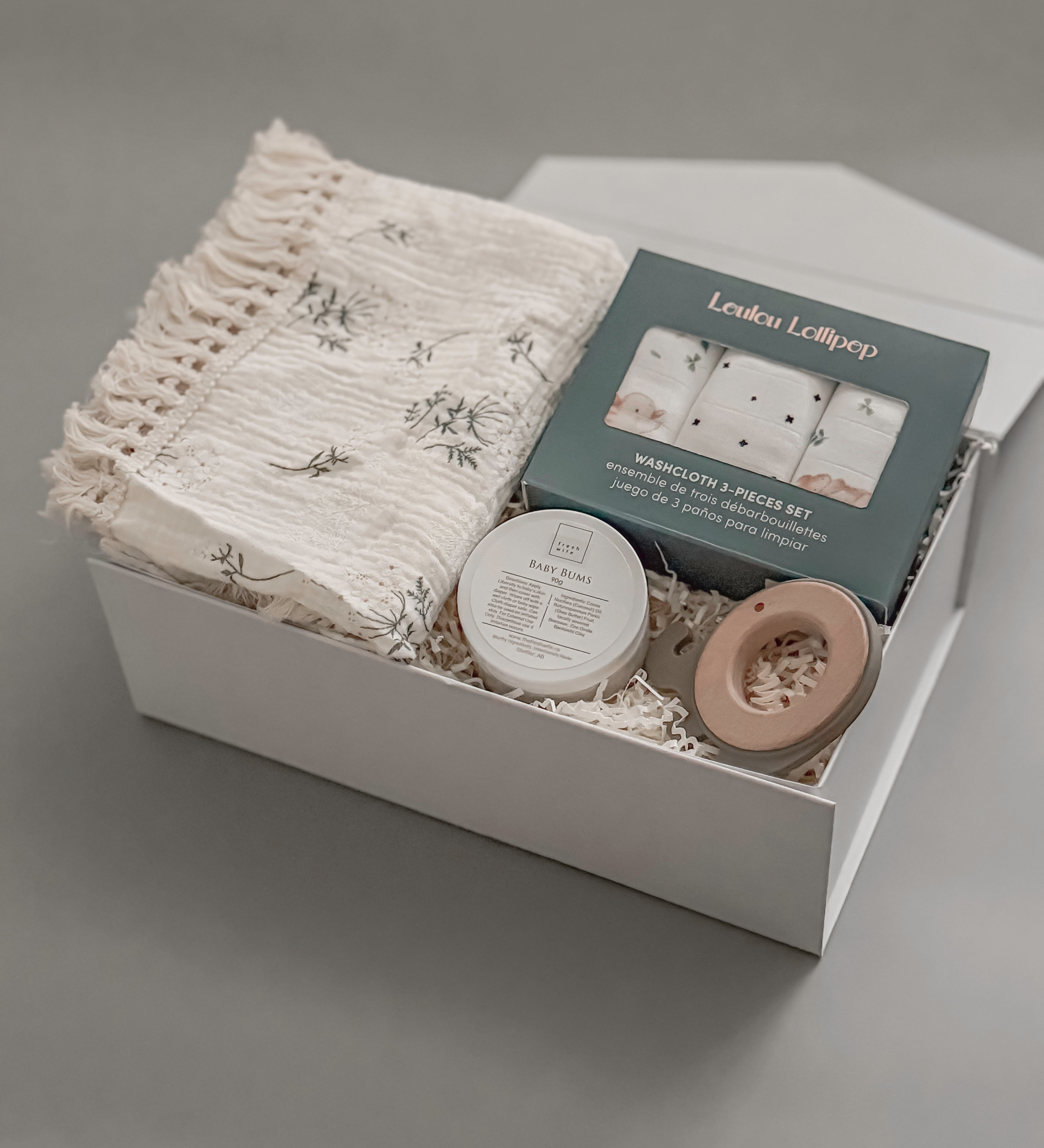 A thoughtfully curated baby gift box featuring Canadian artisan brands. Soft, neutral, and made for the earliest days of new life.