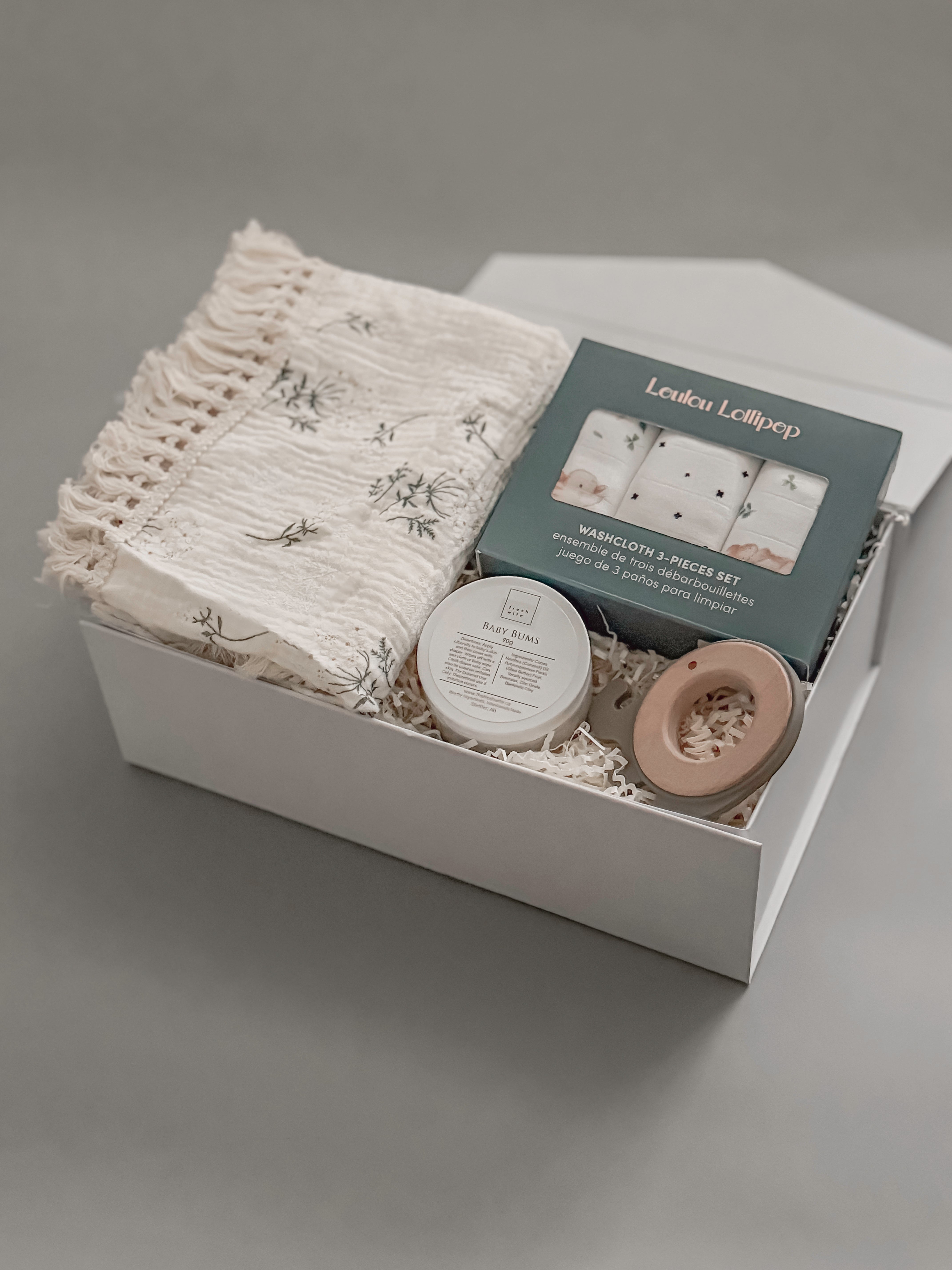 A thoughtfully curated baby gift box featuring Canadian artisan brands. Soft, neutral, and made for the earliest days of new life.