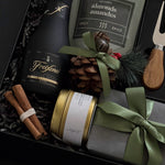 Gift set with wine, nuts, and decorative items in a box