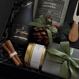 Gift set with wine, nuts, and decorative items in a box