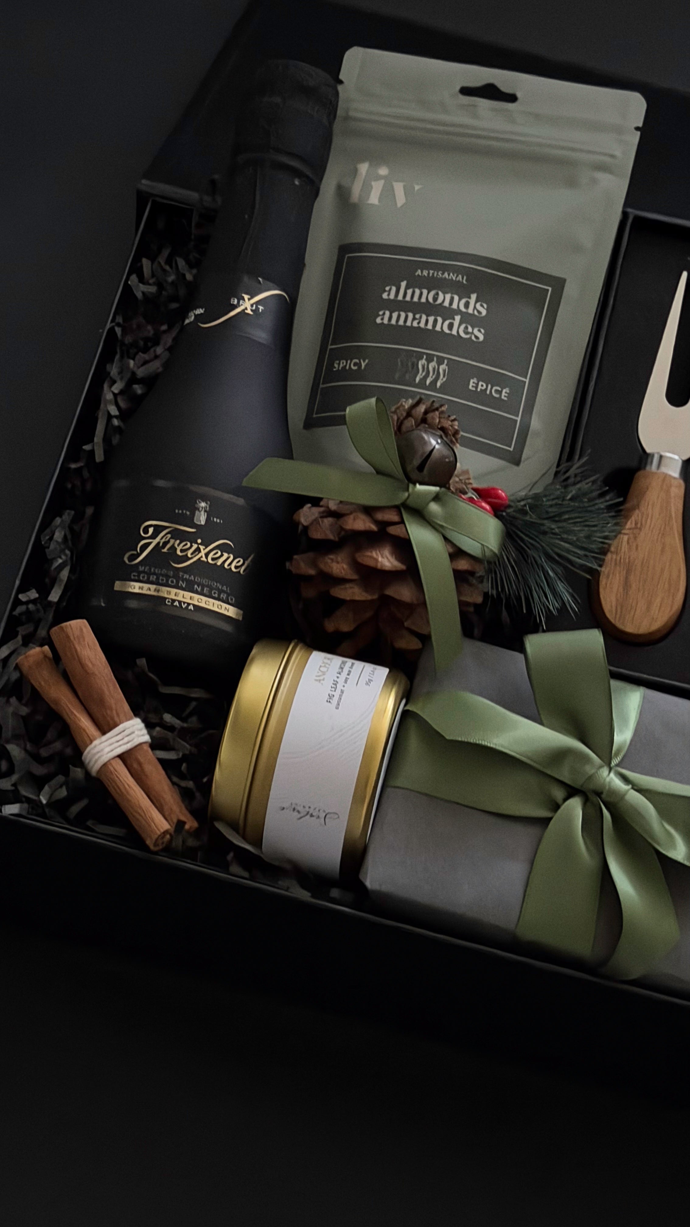 Gift set with wine, nuts, and decorative items in a box