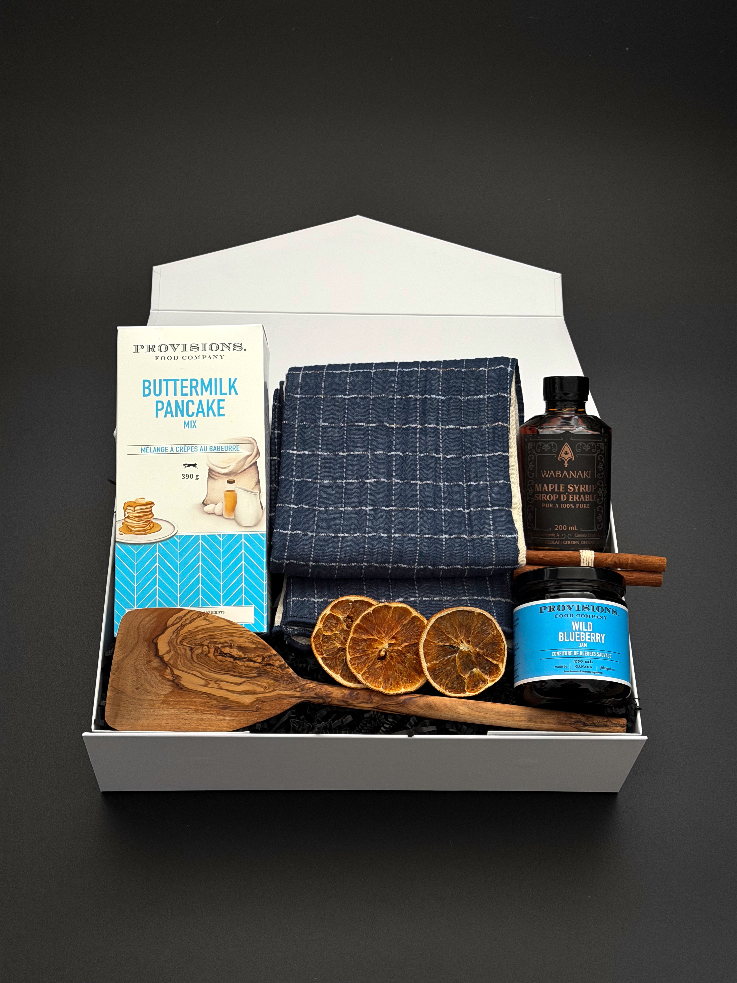 The Chalet Breakfast holiday gift box by Muse Baskets and Co. with pancake mix, maple syrup and blueberry jam in a pearl white box.