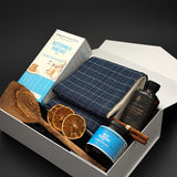 Open pearl white breakfast gift box by Muse Baskets and Co. with blueberry jam, dried orange accents and cinnamon styling for holiday gifting.