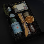 Close-up of luxury holiday gift box featuring Freixenet sparkling wine, assorted chocolates, and artisan treats — perfect for corporate gifting.