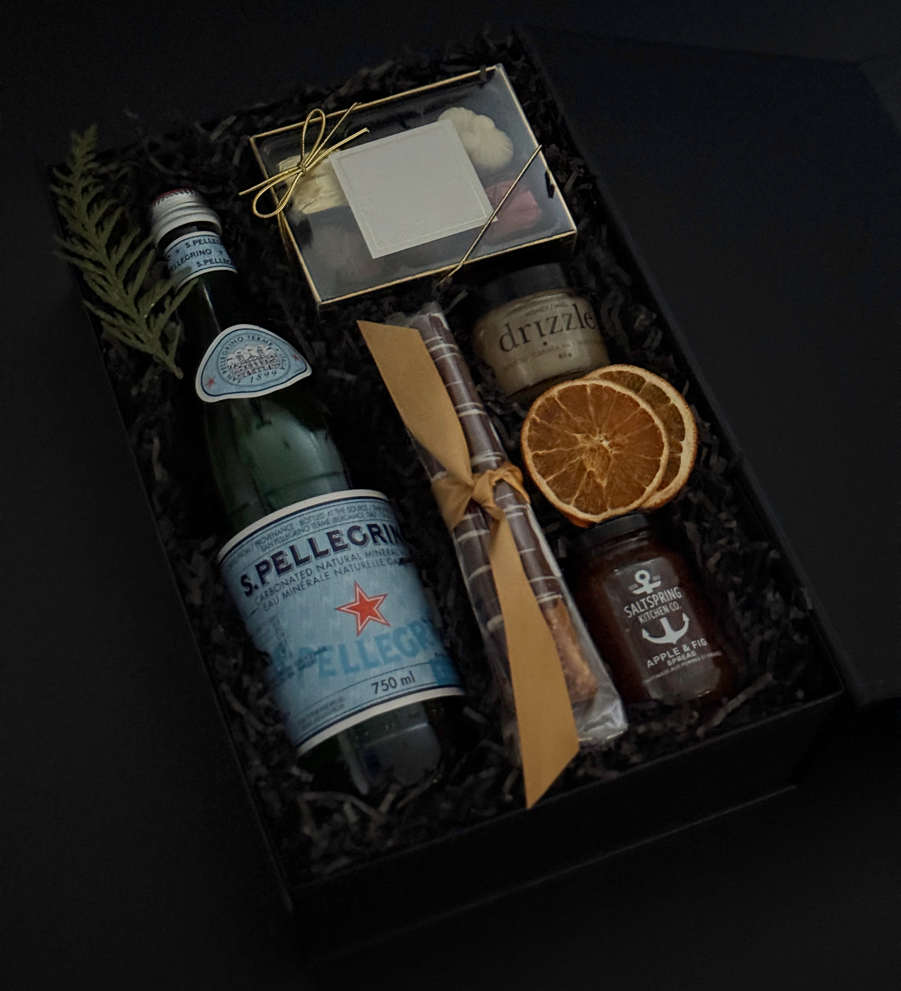 Close-up of luxury holiday gift box featuring Freixenet sparkling wine, assorted chocolates, and artisan treats — perfect for corporate gifting.