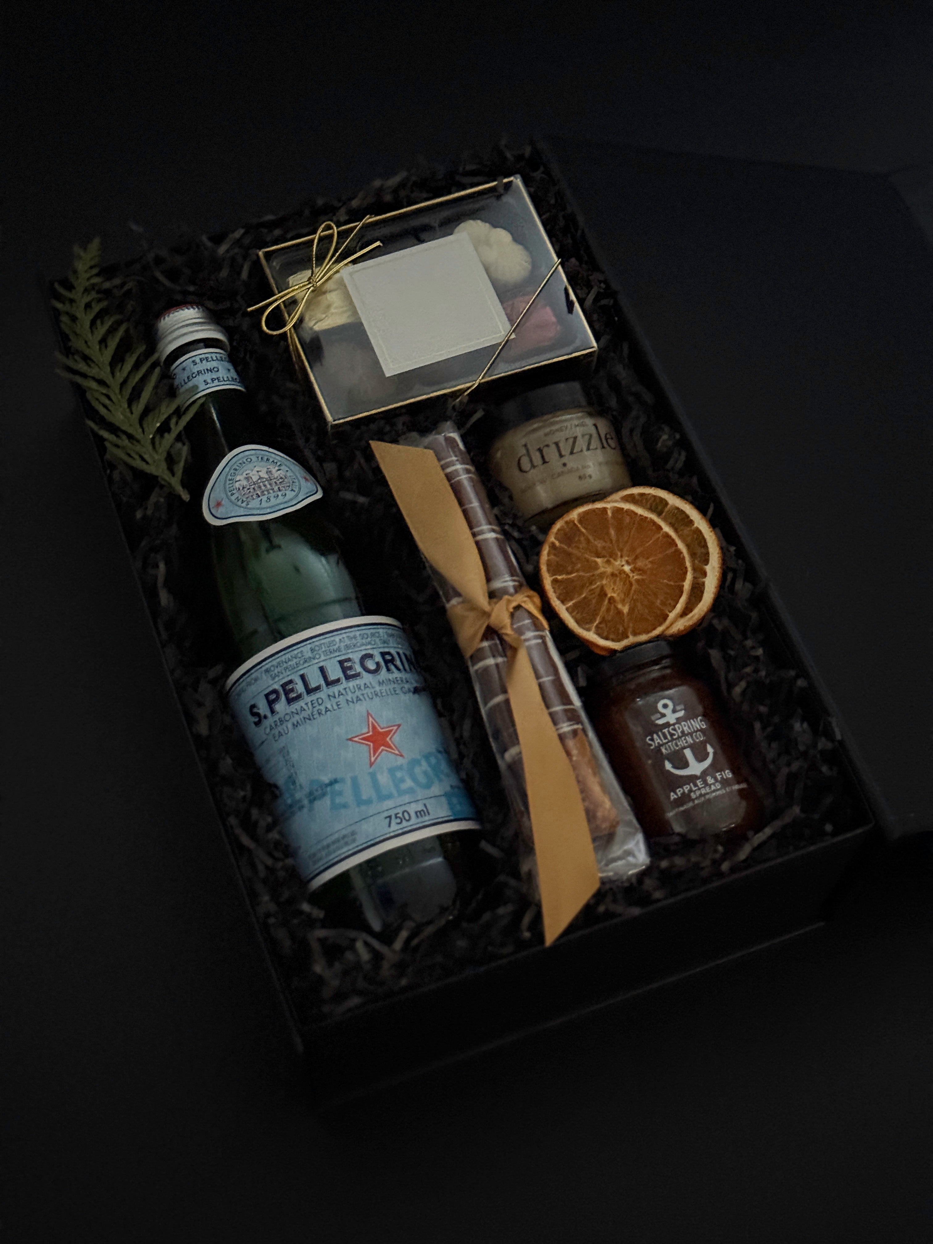 Close-up of luxury holiday gift box featuring Freixenet sparkling wine, assorted chocolates, and artisan treats — perfect for corporate gifting.