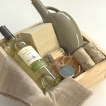 Vancouver Thanksgiving gift basket by Muse Baskets and Co. with Mission Hill wine, Vancouver Candle Co. candle, Matchstick Boutique matches, Gharyan Stoneware pieces and Danica Brands dishtowels in a wood gift box.
