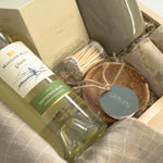 Luxury Thanksgiving gift basket by Muse Baskets and Co. with white wine, candlelight, kitchen staples and Canadian-made home goods arranged in a signature wood gift box.