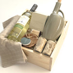 The Harvest Host gift basket by Muse Baskets and Co. designed for Thanksgiving, possession day and housewarming gifting, with wine, candlelight and useful kitchen pieces in a wood presentation box.