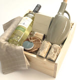 The Harvest Host gift basket by Muse Baskets and Co. designed for Thanksgiving, possession day and housewarming gifting, with wine, candlelight and useful kitchen pieces in a wood presentation box.
