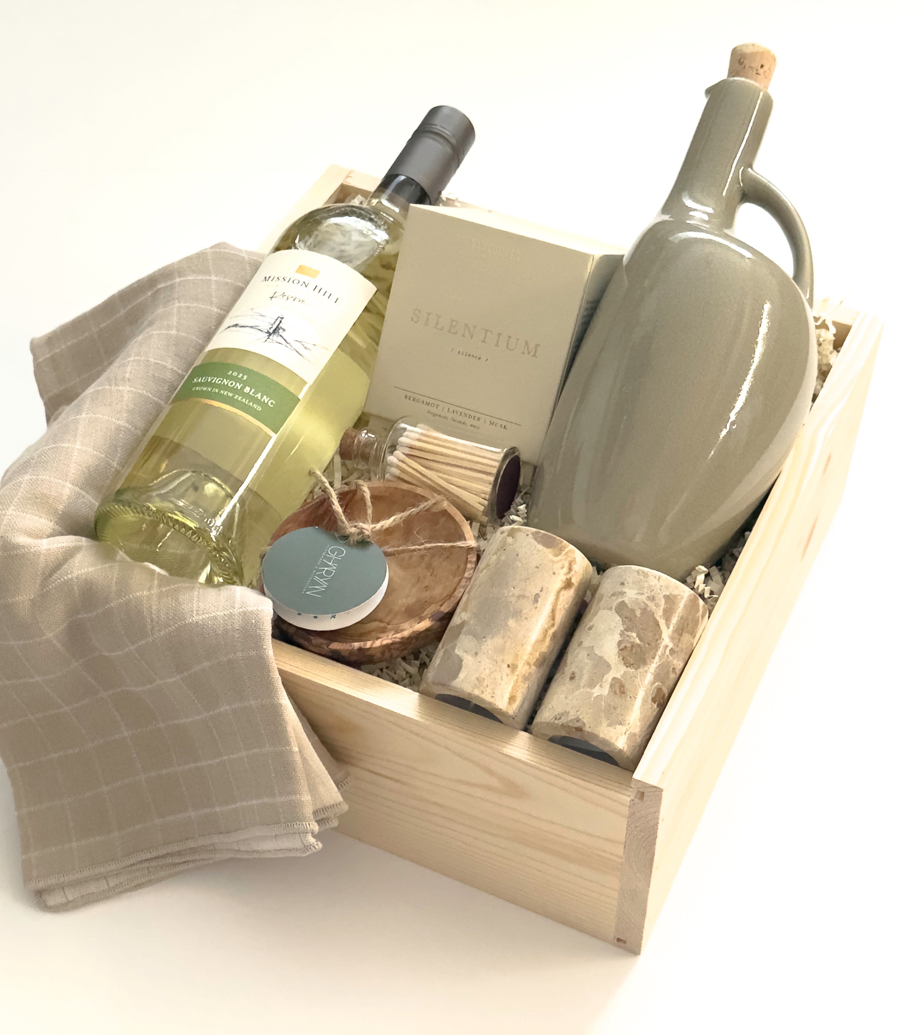 The Harvest Host gift basket by Muse Baskets and Co. designed for Thanksgiving, possession day and housewarming gifting, with wine, candlelight and useful kitchen pieces in a wood presentation box.