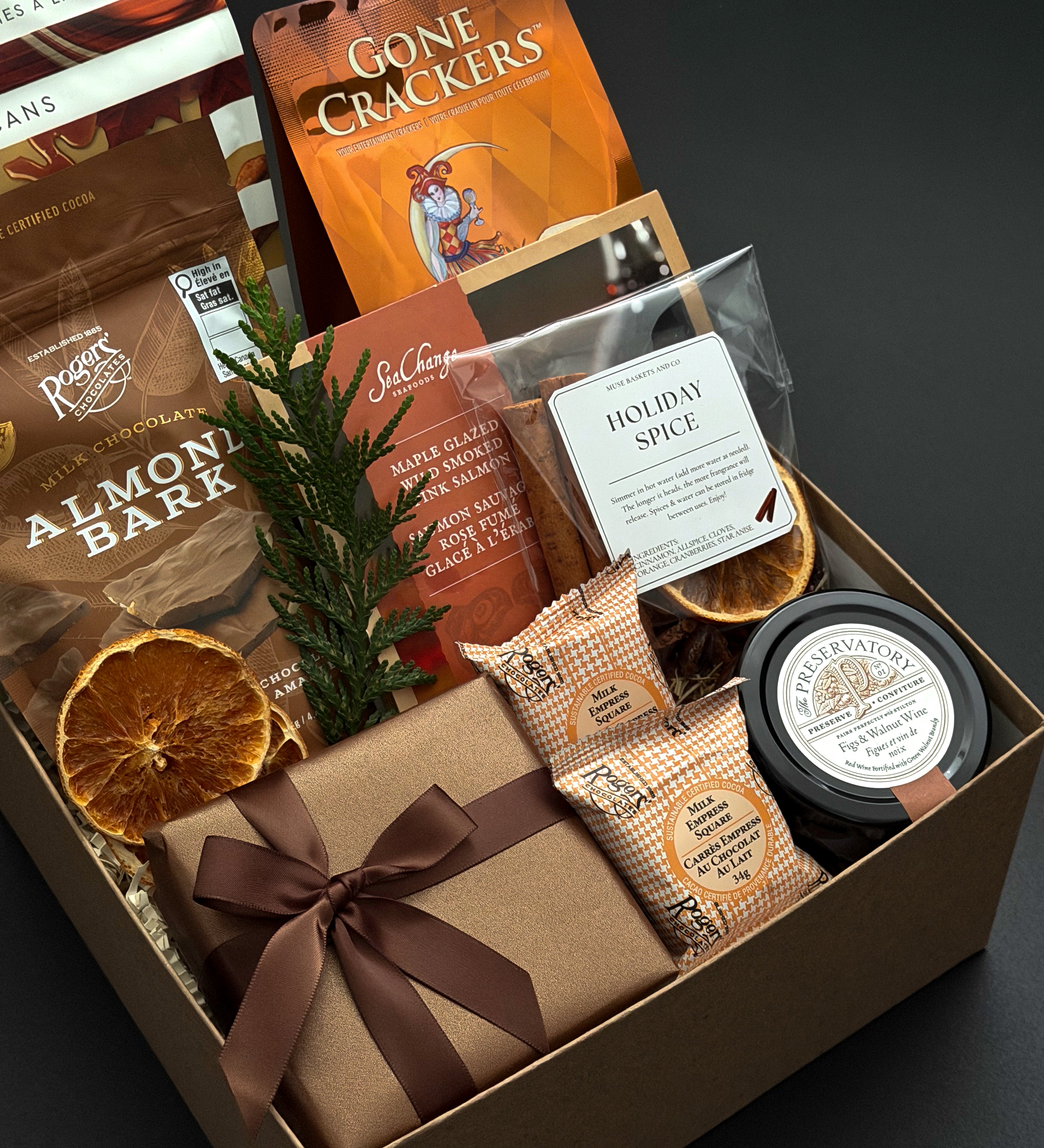 Cedar & Clove corporate holiday gift by Muse Baskets and Co. featuring SeaChange maple glazed salmon, Castello Brie and Parmesan & Garlic Crackers by Gone Crackers.