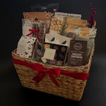 The Holiday Gathering Basket filled with gourmet chocolates and artisan snacks by Muse Baskets and Co.
