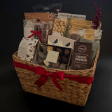 The Holiday Gathering Basket filled with gourmet chocolates and artisan snacks by Muse Baskets and Co.