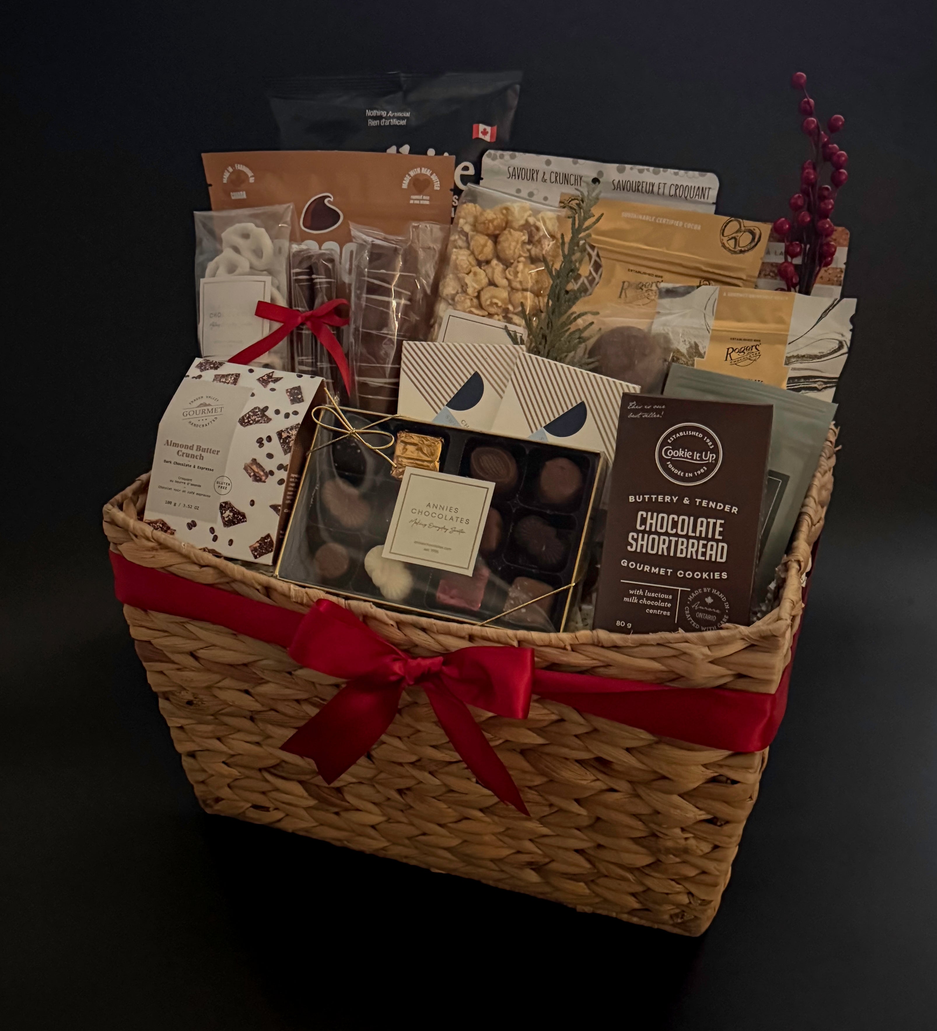 The Holiday Gathering Basket filled with gourmet chocolates and artisan snacks by Muse Baskets and Co.