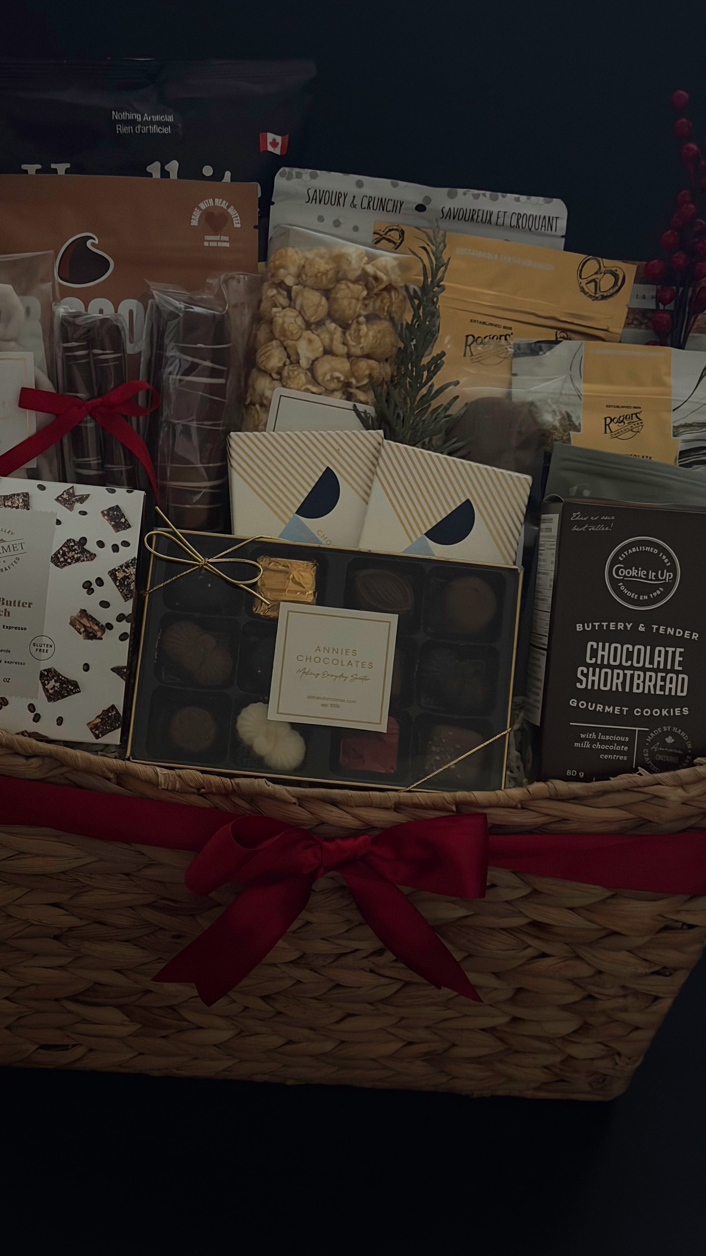 Holiday office share gift basket with chocolate, popcorn, and cookies.