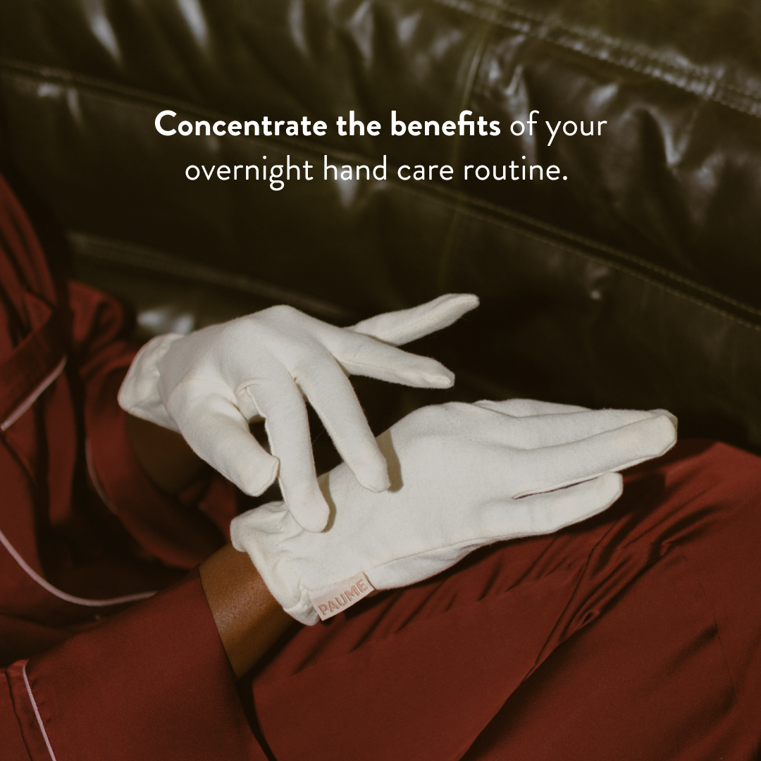 A pair of soft, white organic cotton overnight gloves from PAUME, laid out cleanly against a neutral background to showcase their lightweight, comfortable design for hand care treatments.
