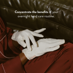 A pair of soft, white organic cotton overnight gloves from PAUME, laid out cleanly against a neutral background to showcase their lightweight, comfortable design for hand care treatments.