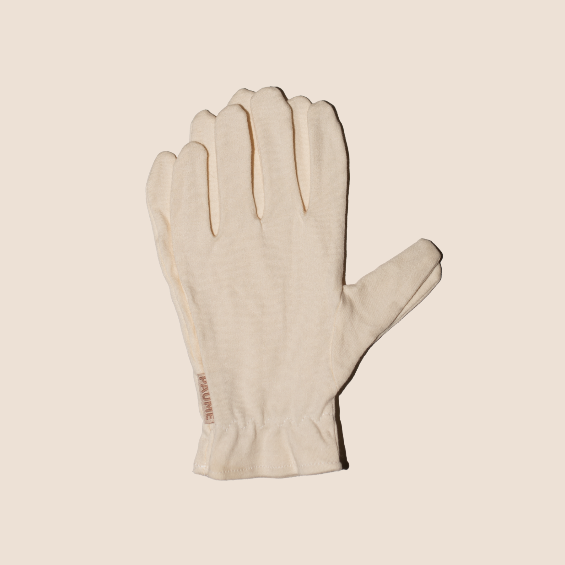 White glove on a beige background
