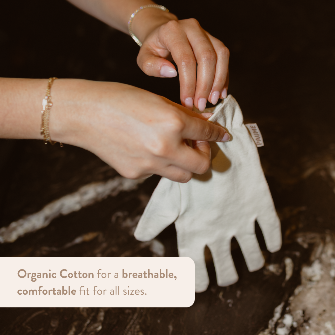 Person holding a white glove with text about organic cotton on a natural background