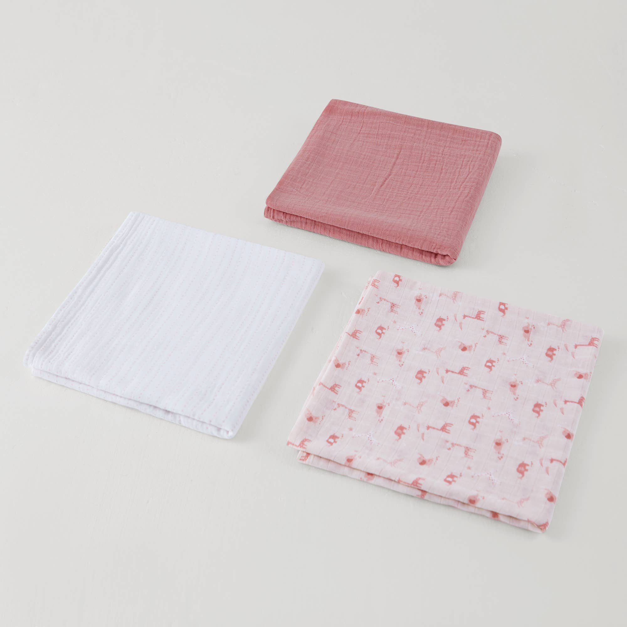 Three swaddles, prink, white and pink elephants on a light background