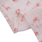 Pink fabric with giraffe pattern on a white background
