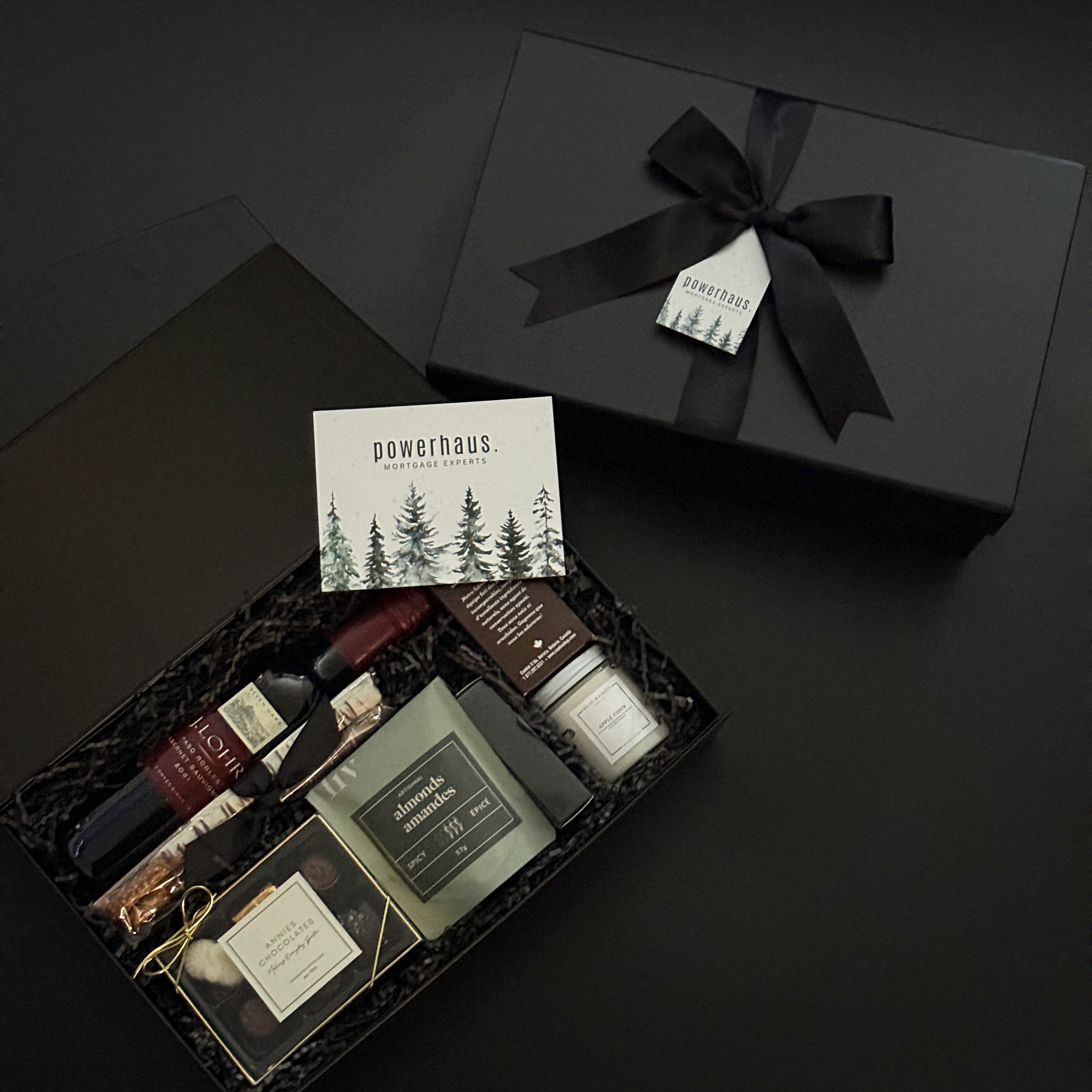 Luxury corporate gift box by Muse Baskets and Co. featuring artisanal candles, chocolates, wine, and wellness products, custom-branded for Powerhaus Mortgage Experts.