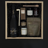 Corporate client gift box with sparkling wine, chocolate, almonds, and artisan candle.