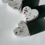Reverie heart-shaped bath bombs decorated with dried flowers, a self-care product featured in Muse Baskets and Co. gift baskets