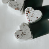 Reverie heart-shaped bath bombs decorated with dried flowers, a self-care product featured in Muse Baskets and Co. gift baskets