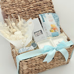 Woven gift basket with a white bow on a light background