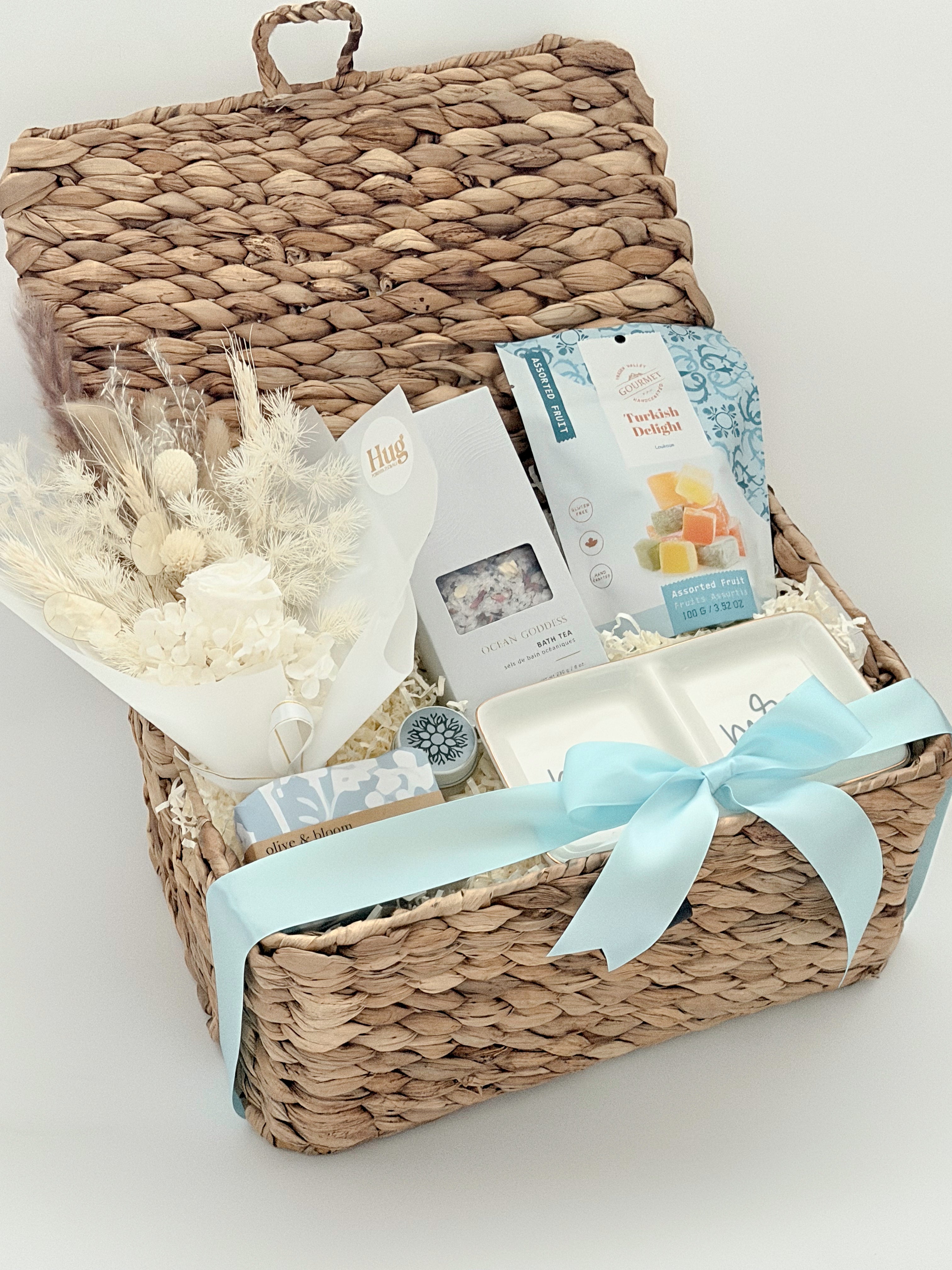 Woven gift basket with a white bow on a light background