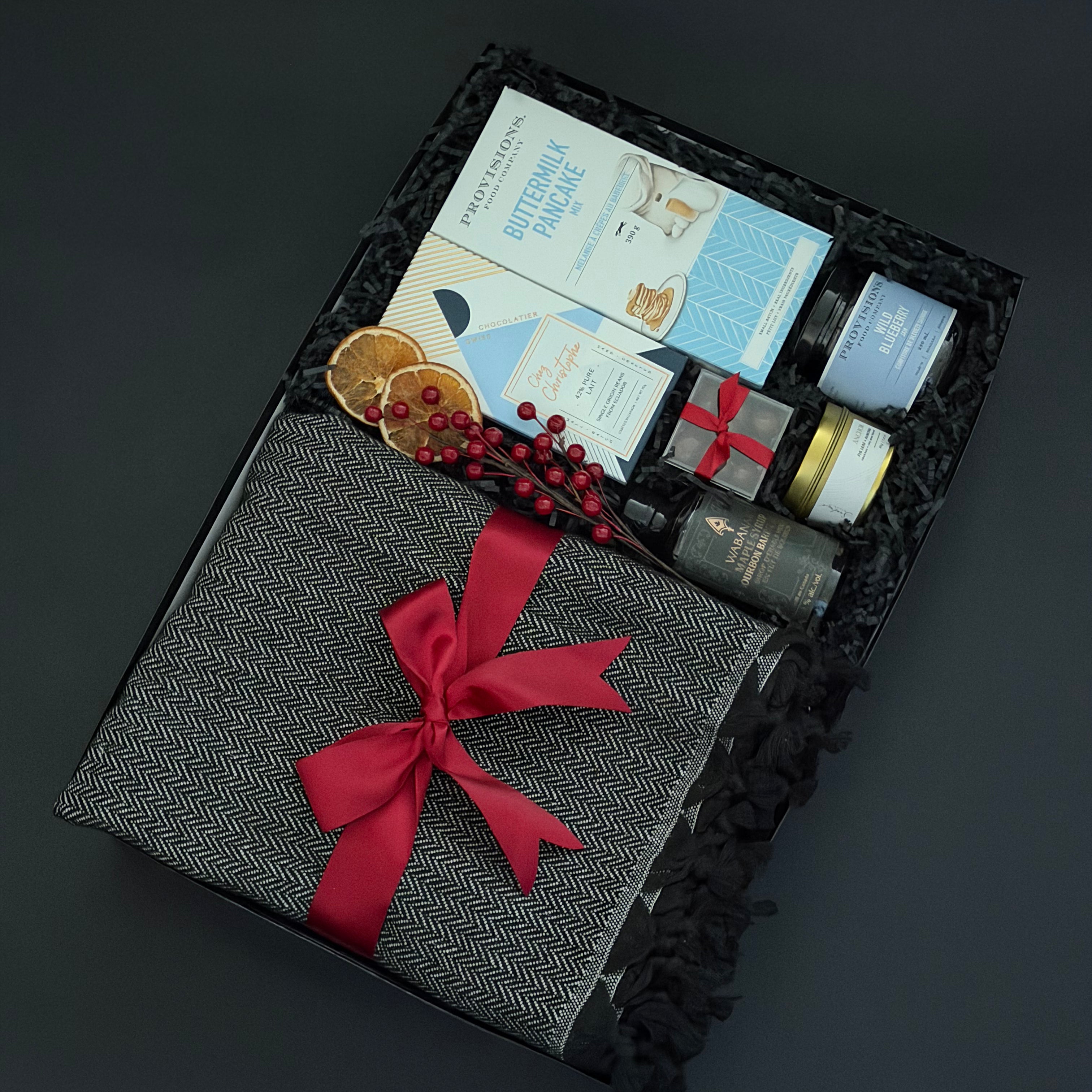 Gift set with a red bow on a dark background for Staples Canada