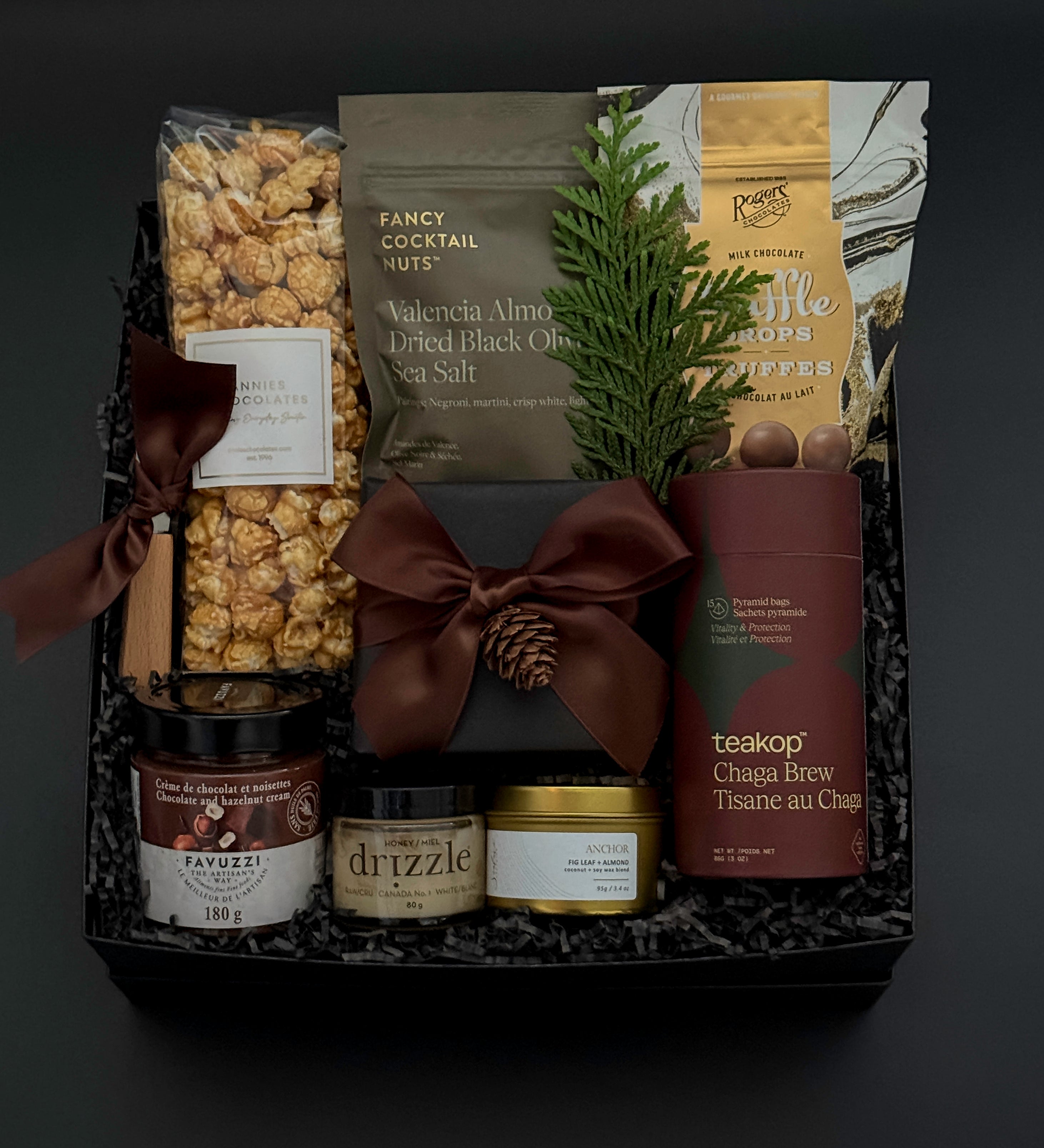 Elegant client appreciation gift box featuring sweet and savoury artisan foods and a gold tin candle.