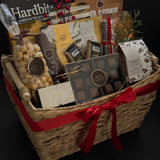 Woven holiday gift basket by Muse Baskets and Co. with Canadian-made chocolates, snacks, crackers and satin ribbon for client appreciation and employee gifting.